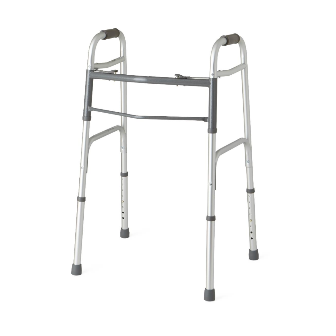 The Medline Two-Button Adult Folding Walker is a sleek mobility solution made of silver aluminum, featuring height-adjustable legs, black rubber tips, and ergonomic hand grips. Its simple and sturdy design ensures reliable support for enhanced mobility.